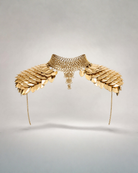 Gold metal shoulder armor body jewelry with overlapping scales, chainmail choker, and draped side chains.
