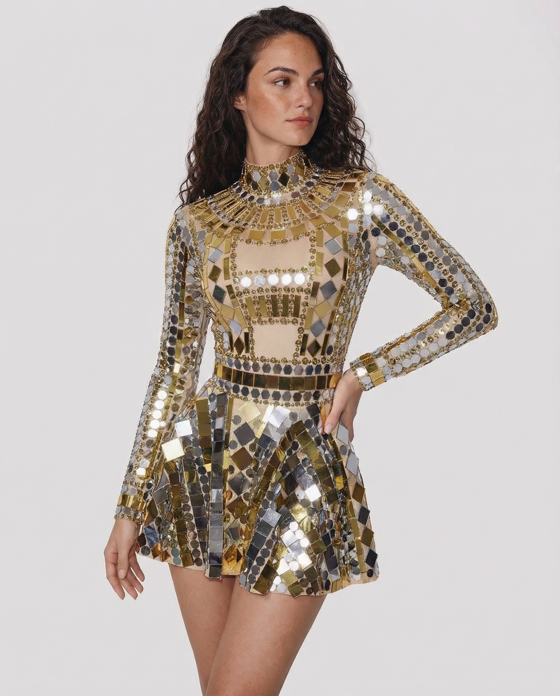 Gold sequin party dress with long sleeves, high neck, and mirrored geometric embellishments.