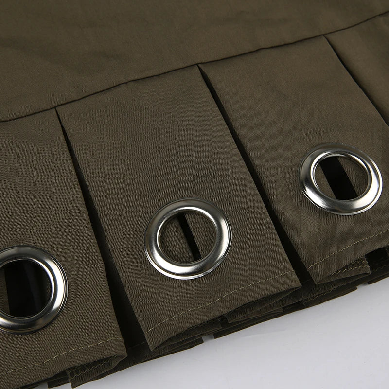 Close-up of the pleated design and metal grommets on the Green Rave Mini Skirt.