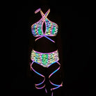 close-up holographic reflective bikini set with vibrant colors and patterns illuminating in darkness