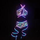 holographic reflective bikini set close-up vibrant neon design glowing straps in dark