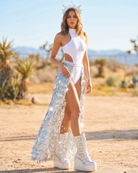 Model wearing the Kay Silver Sequin Maxi Skirt with a white bodysuit in a desert setting.