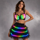Model wearing a black LED bra and tiered tutu skirt with vibrant, remote-controlled multicolored light strips.