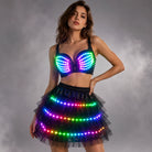 Model wearing a black LED bra and tiered tutu skirt set featuring vibrant, remote-controlled multicolored light strips.