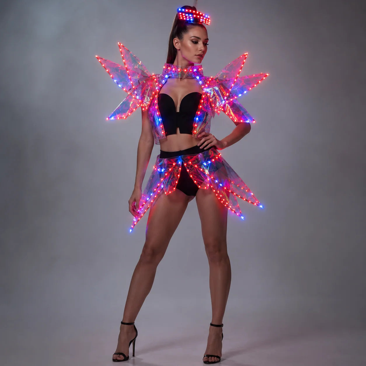 Futuristic LED costume with a glowing acrylic visor and light-up structural wings in red and blue on a gray background.