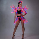 Futuristic LED costume with a glowing acrylic visor and light-up structural wings in red and blue on a gray background.