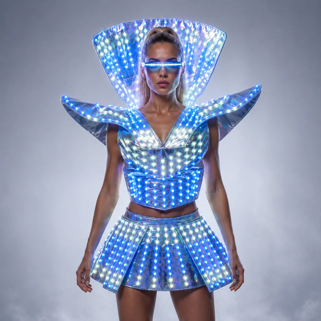 Futuristic LED shoulder armor dress with a metallic finish, glowing blue lights, and matching visor for festival performances.