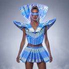 Futuristic LED shoulder armor dress with a metallic finish, glowing blue lights, and matching visor for festival performances.