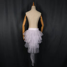White tiered tulle LED tutu skirt on a mannequin, featuring a high-low hemline and integrated lighting components.