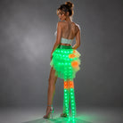 Model wearing a layered tulle LED tutu skirt featuring glowing green and orange lights with a remote-controlled design.