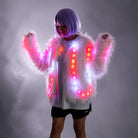 Plush white faux fur jacket featuring integrated remote-controlled LED lights glowing in vibrant pink and white.