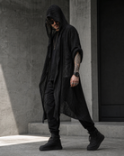 Man wearing a black, textured, long-sleeved hooded cardigan made of lightweight polyester in a modern, edgy style.