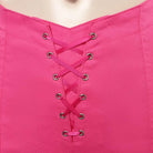Close-up of a fuchsia spandex top with a central lace-up design featuring silver grommets and matching ribbon.