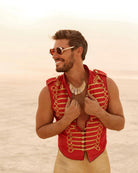 Round Steampunk Sunglasses worn by a smiling man in a red vest against a desert background.