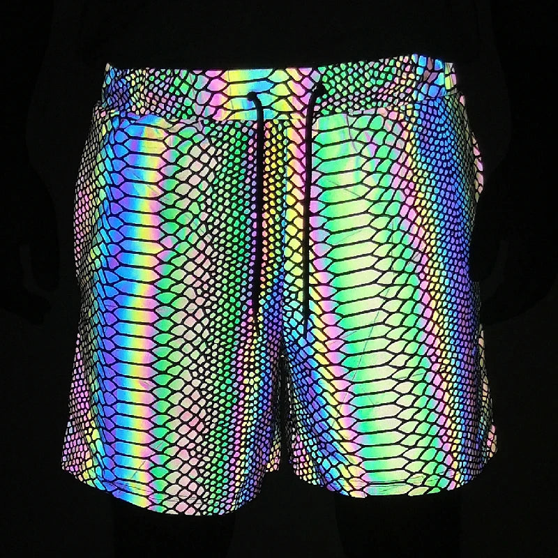 Men's reflective festival shorts with a vibrant, iridescent snakeskin pattern and black drawstring.
