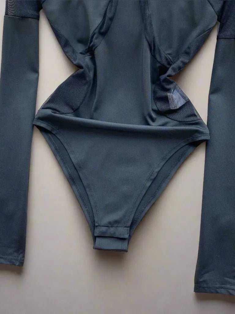 Dark grey polyester mesh patchwork bodysuit with long sleeves.