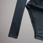 Close-up of the sleeve and fabric detail of the Mesh Patchwork Bodysuit, showcasing its lightweight material.