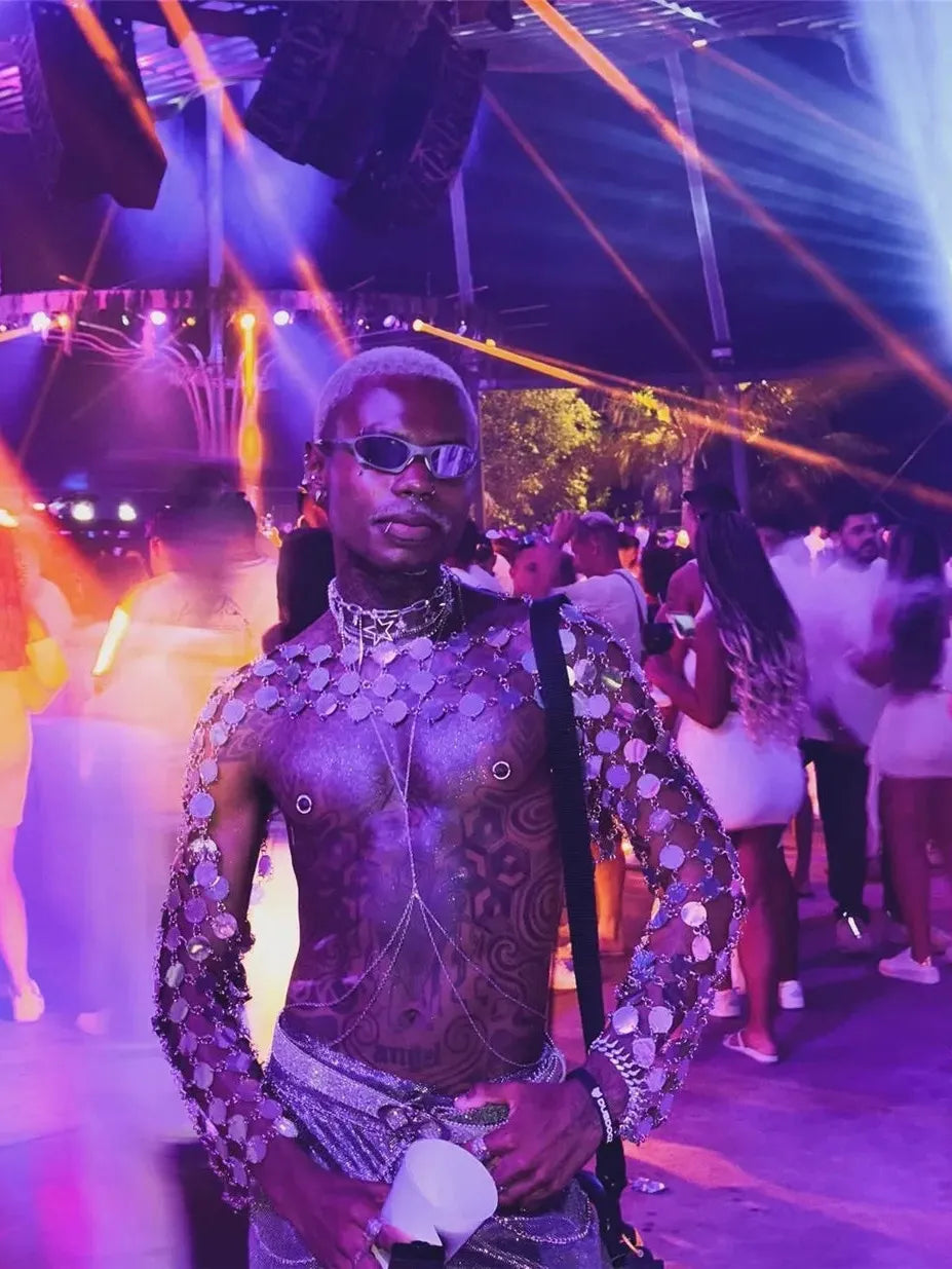 metal chain disc crop top close-up showing model in vibrant nightlife with disco lights