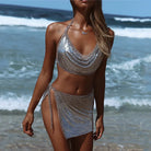 full-shot metallic top and skirt set in silver at beach with ocean waves background