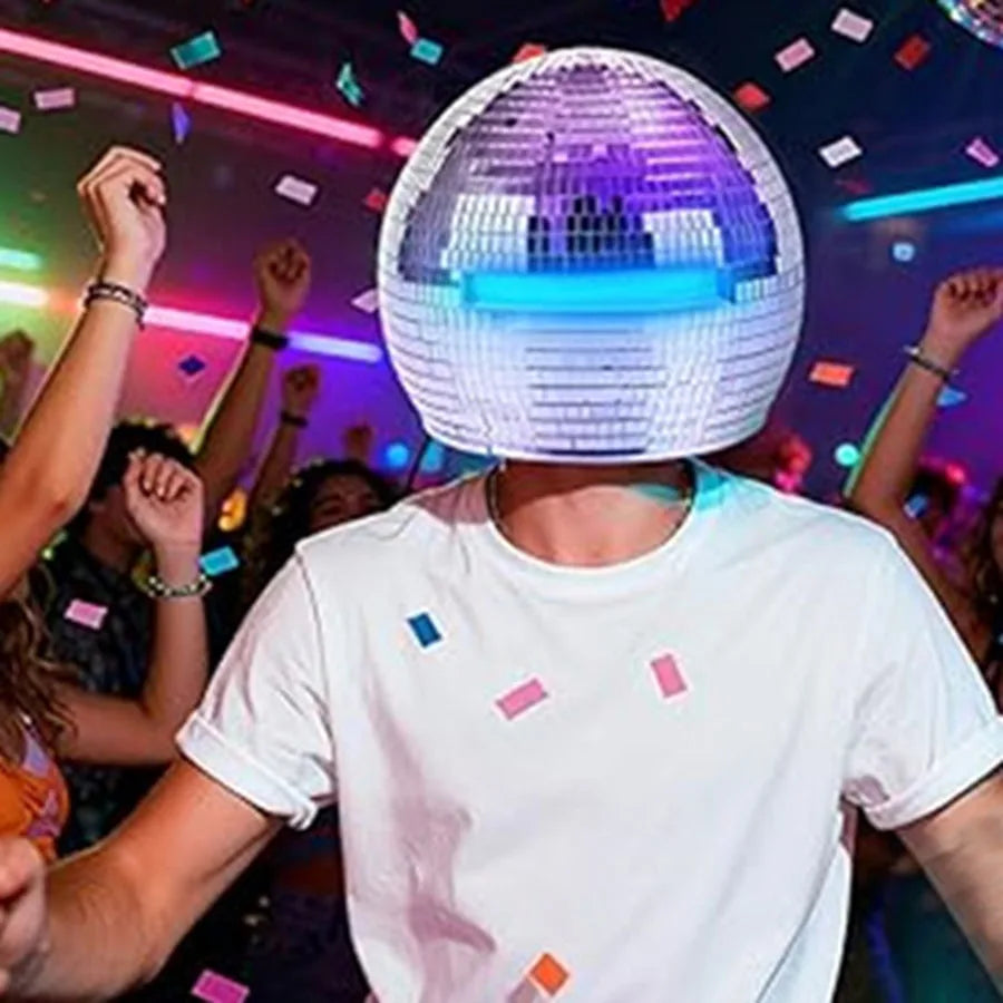 Adult wearing a 40cm Mirror Disco Ball Helmet with built-in blue lights, surrounded by confetti at a party.