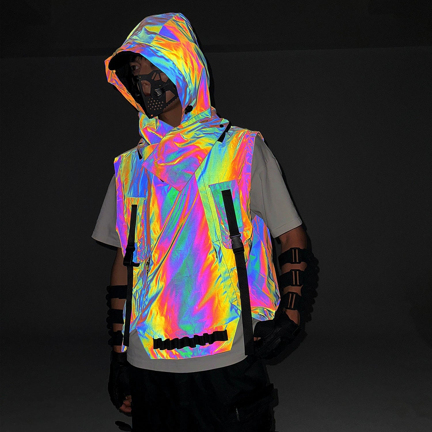 Multicolor reflective techno vest with hood, worn over a white tee, showcasing its iridescent glow in darkness.