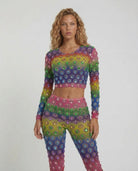 Multicolor rhinestone mesh 2-piece set with cropped top and high-waisted flared pants on a model.