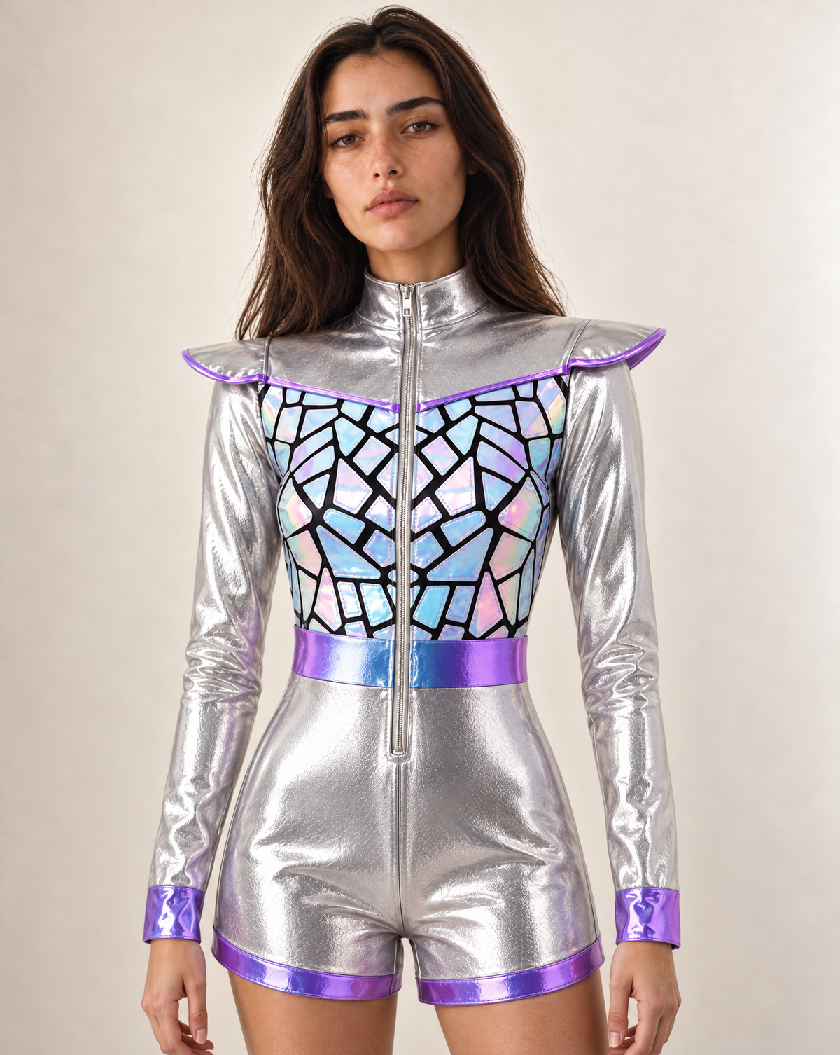 Model wearing a metallic silver faux leather bodysuit with iridescent geometric panels and purple trim accents.
