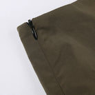 Close-up of zipper detail on green fabric, showcasing quality for Green Rave Mini Skirt.