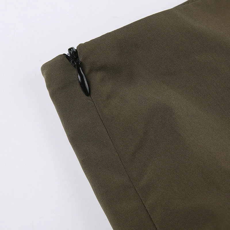 Close-up of zipper detail on green fabric, showcasing quality for Green Rave Mini Skirt.
