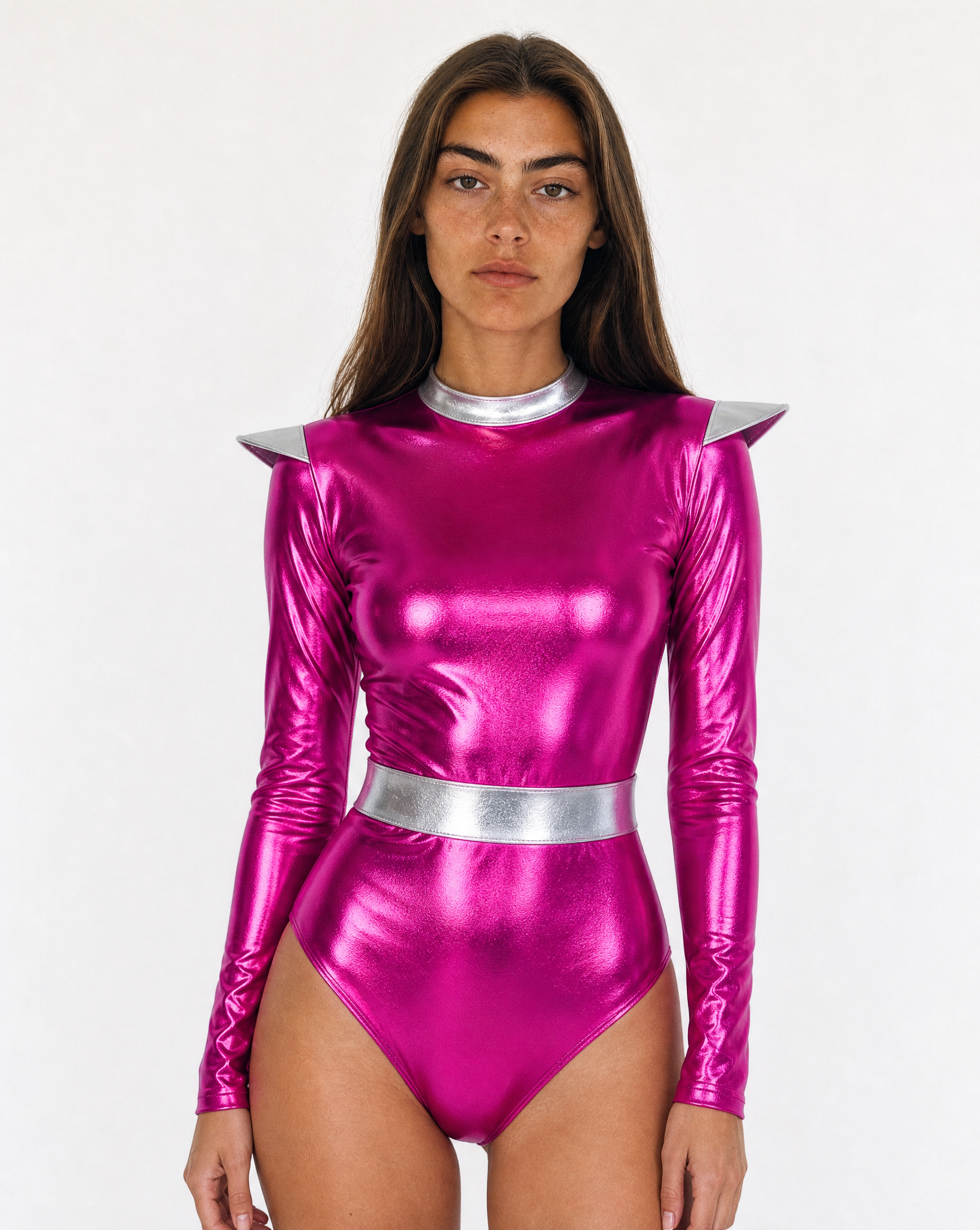 Model wearing a metallic pink faux leather bodysuit with silver shoulder accents and a high-shine futuristic finish.
