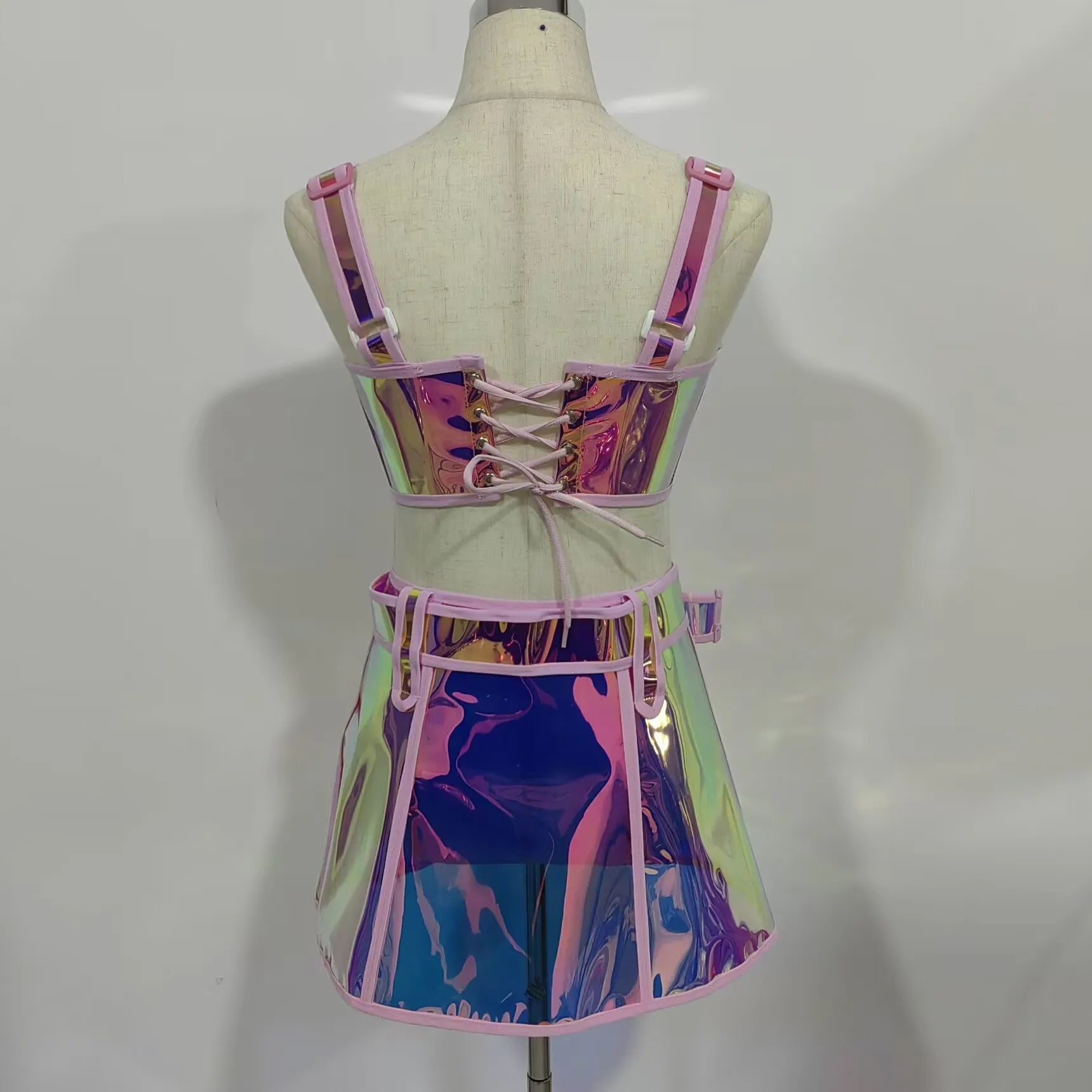 Back view of Pink Reflective Top and Skirt Set showcasing its shiny, vibrant design and lace-up details.