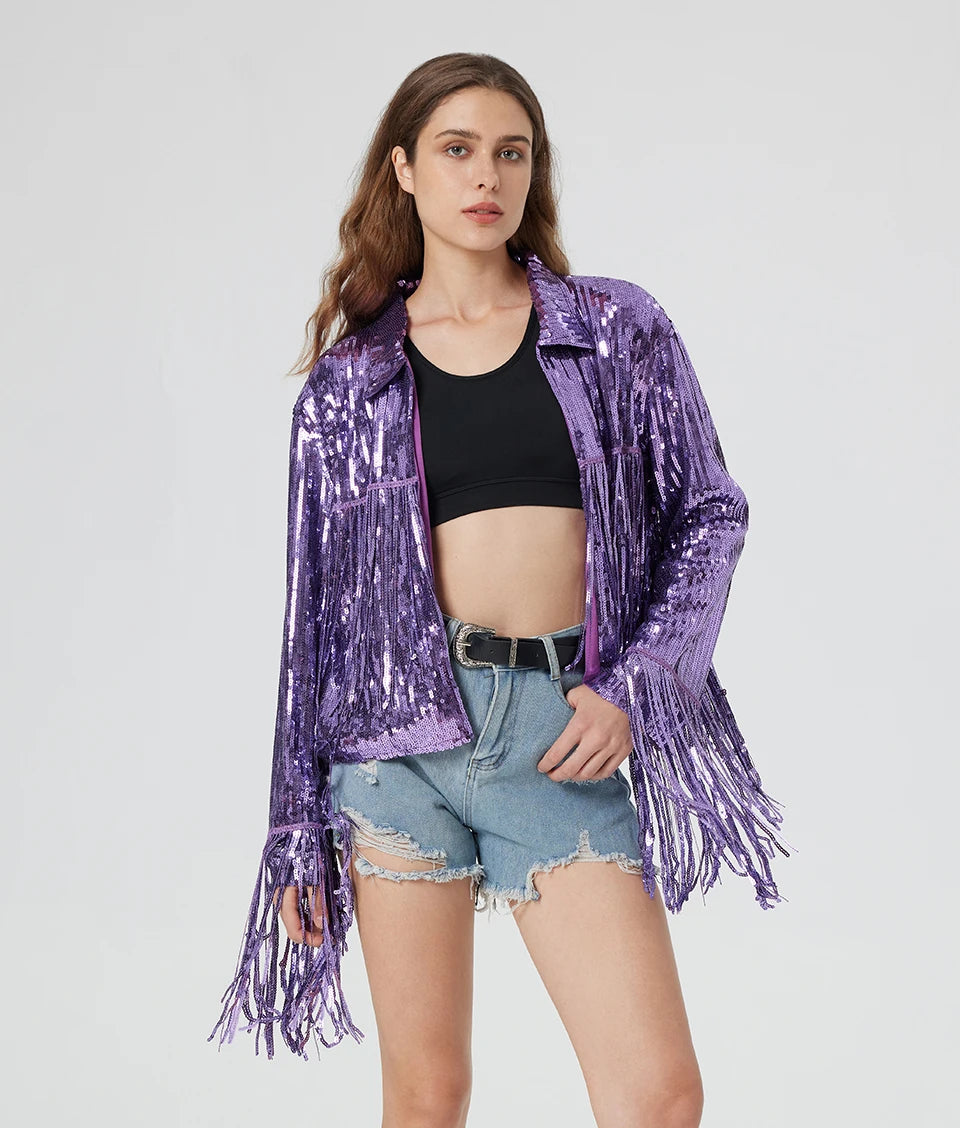 Purple metallic sequin jacket with long fringe trim, worn over a black crop top and denim shorts.