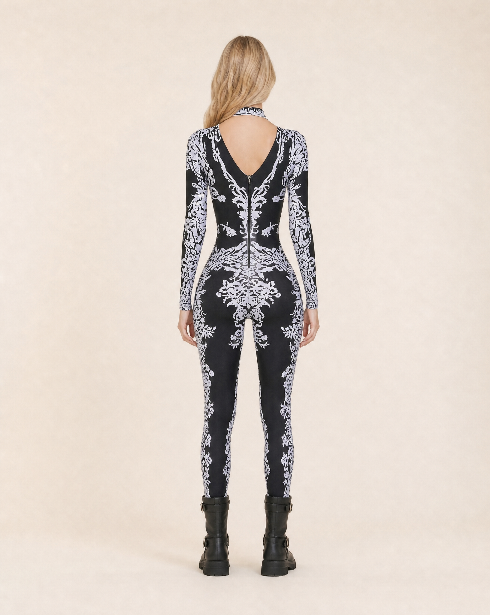 Reagan Black Rhinestone Jumpsuit, full-body, long-sleeved, with intricate white baroque patterns.