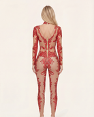 Back view of a red rhinestone and sequin jumpsuit with a sheer spandex base and concealed back zipper closure.