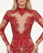 Red long-sleeve jumpsuit featuring intricate hand-glued rhinestones and sequins on a sheer, form-fitting spandex base.