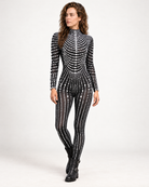 Model wearing a black long-sleeve jumpsuit adorned with intricate white pearl patterns and a high neckline.