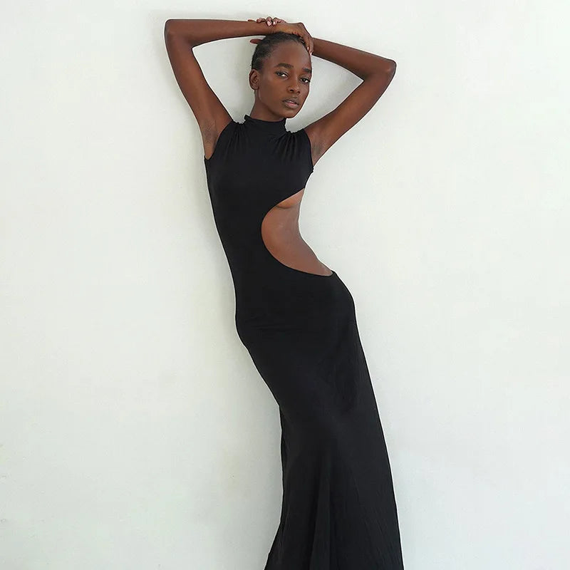 Model showcasing a sleek Cut Out Maxi Dress with high stretch polyester and playful cut outs.