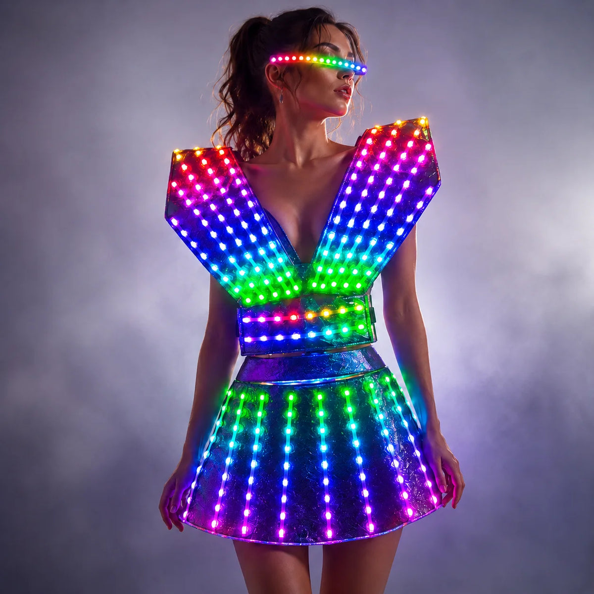 Futuristic LED dress with a glowing rainbow light grid, structured shoulders, and matching light-up visor in a smoky setting.