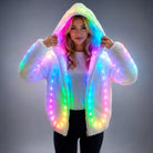Woman wearing a plush white faux fur hooded jacket with integrated, glowing multi-colored LED lights.