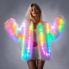 Woman wearing a plush white faux fur jacket featuring integrated, remote-controlled multicolored LED light strips.