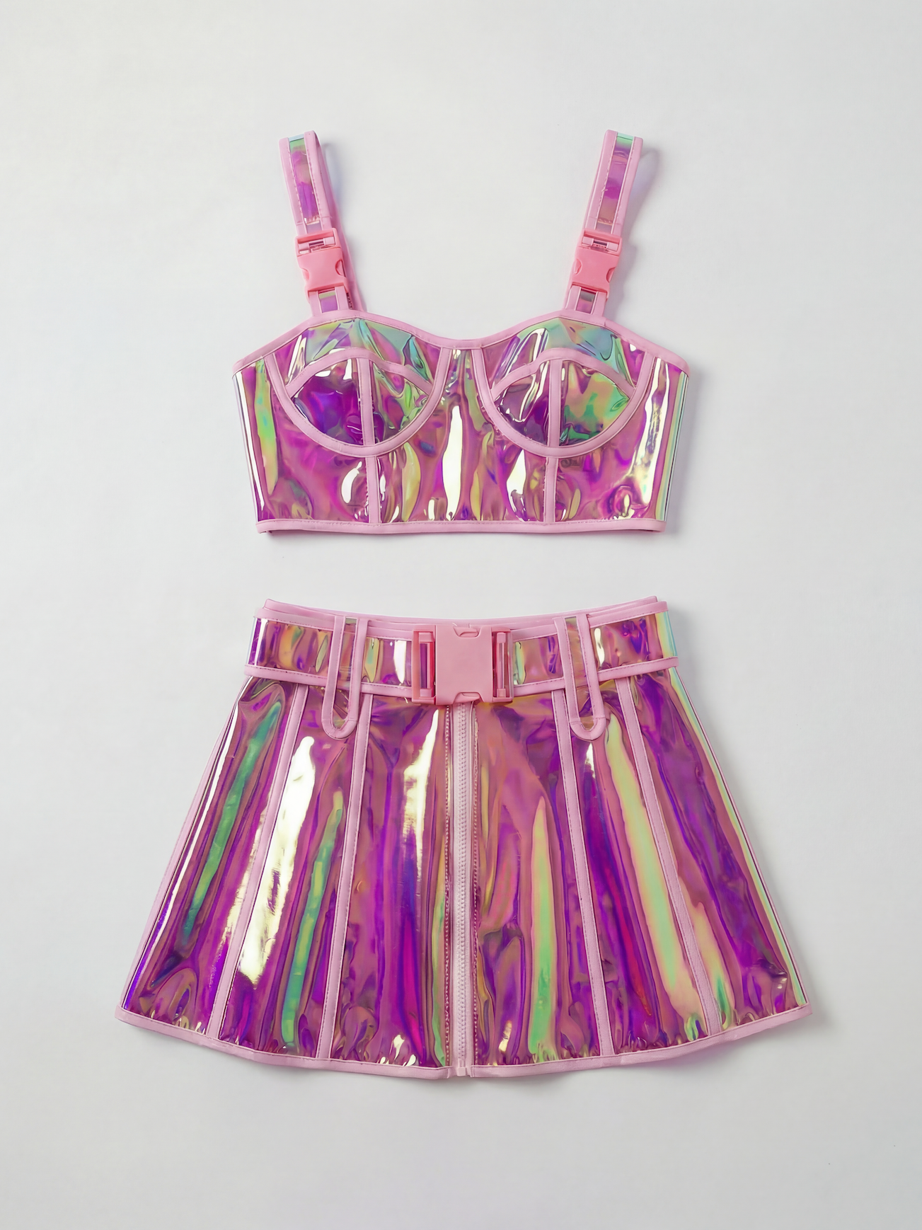 Pink reflective PVC crop top and mini skirt set with pink buckles and trim.