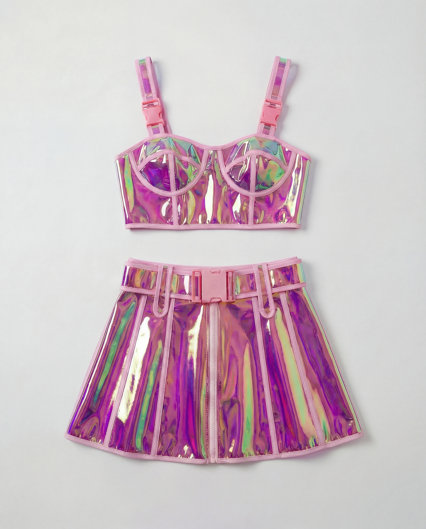 Pink reflective PVC crop top and mini skirt set with pink buckles and trim.