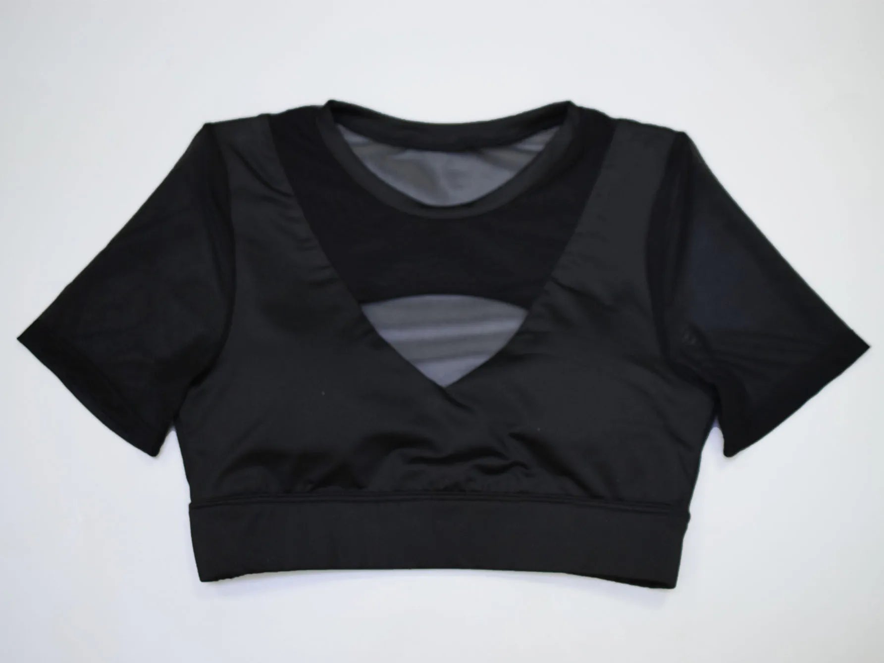 Short Sleeve Top with Sexy Cut in black, featuring a unique cut and soft fabric for a flirty look.