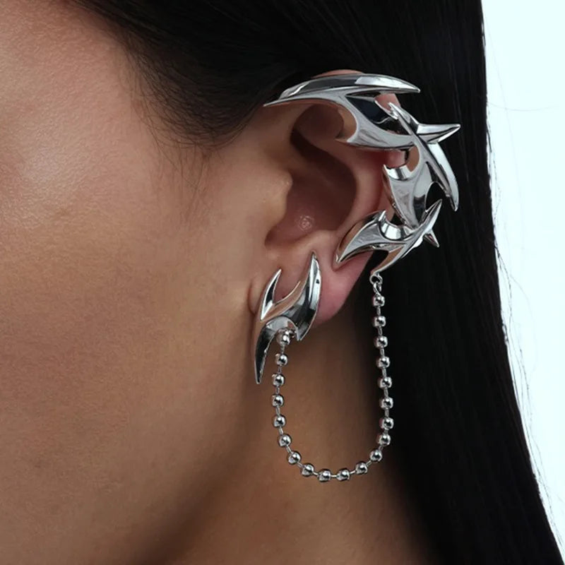 Silver metal full ear cuff with sharp angular spikes and a dangling chain, no piercing required.