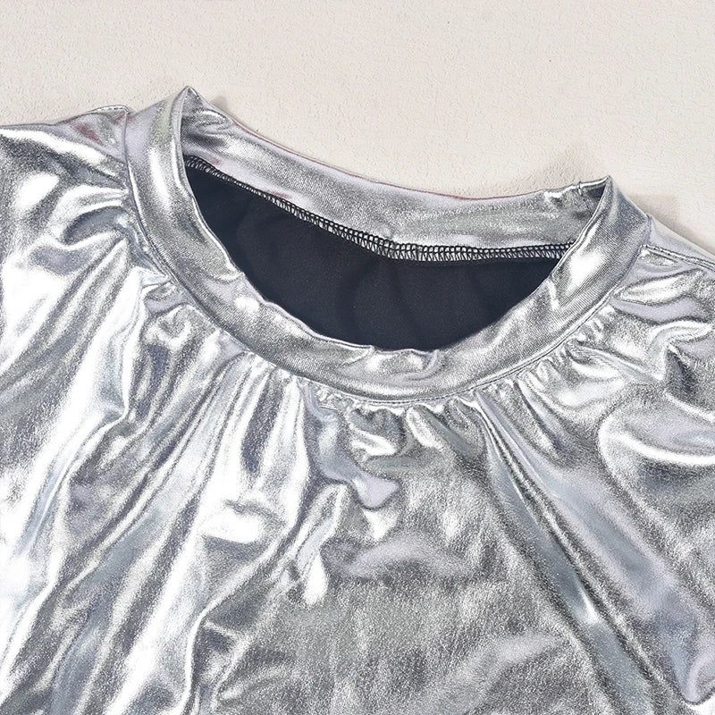 Close-up of the neckline of the Silver Metallic Crop Top & Mini Skirt Set showcasing its shiny fabric.