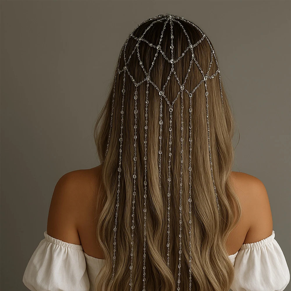 Silver rhinestone fringe chain headband on long wavy brown hair, viewed from behind.