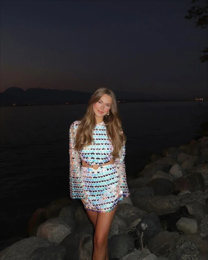Silver Sequin Hollow-Out Mini Party Dress worn by model near water at night, showcasing shimmering design.