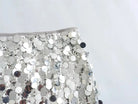 Close-up of Sequin Mini Skirt showcasing shiny silver sequins and high-stretch fabric.