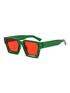 Malmö chunky square sunglasses featuring a translucent green polycarbonate frame and bold red UV-400 resin lenses.