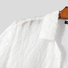 Nahaufnahme eines transparenten T-Shirts mit Quasten, das durchscheinenden Stoff und verspielte Quasten zeigt.